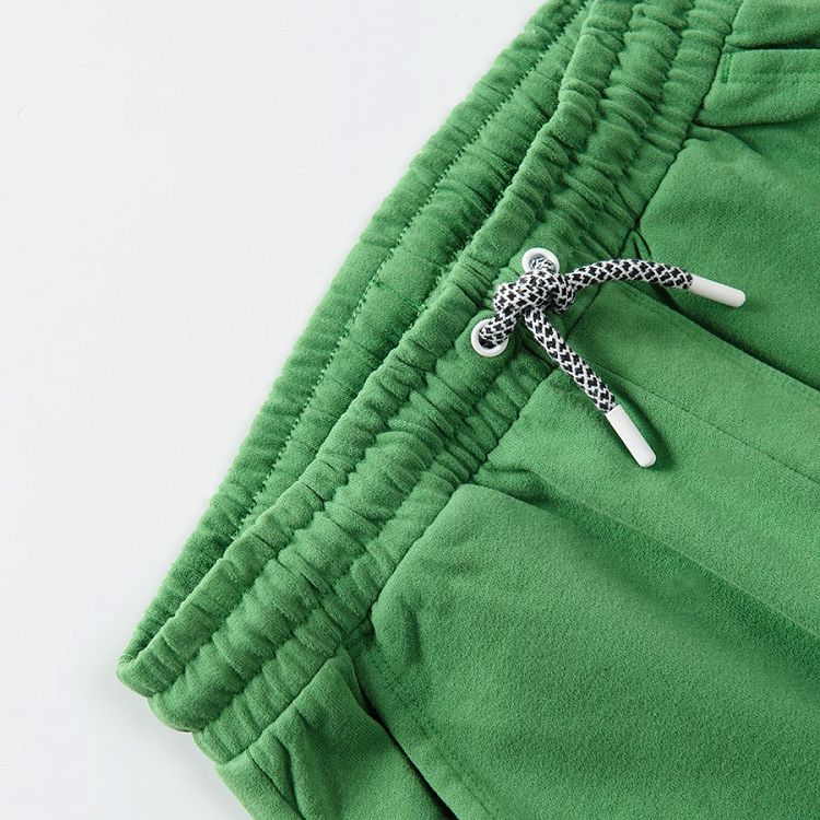 Green jogging pants with cord on the waist and elastic ankle