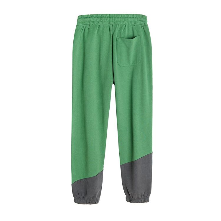 Green jogging pants with cord on the waist and elastic ankle