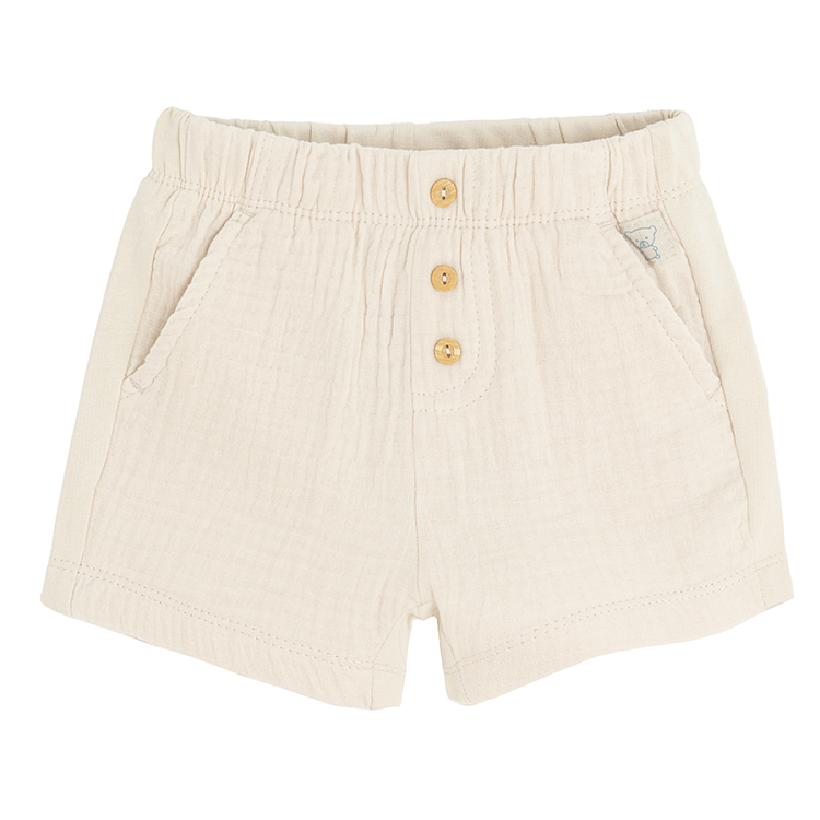 Beige shorts with buttons in the middle