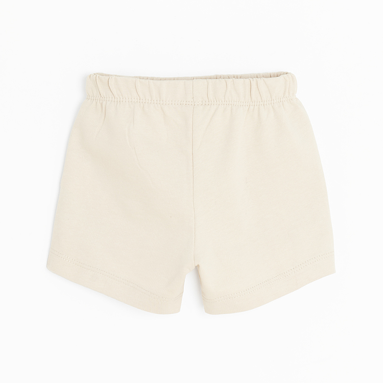 Beige shorts with buttons in the middle