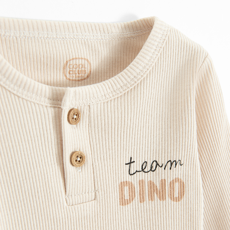 Beige long sleeve bodysuit with buttons and Team Dino print