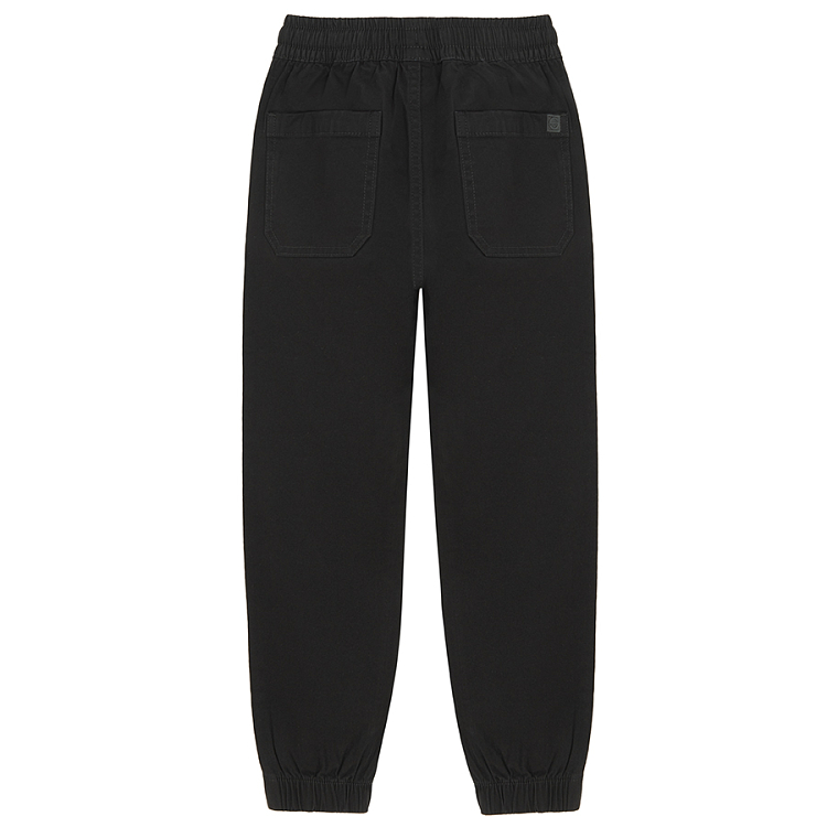 Black trousers with corded waist and elastic around the ankles