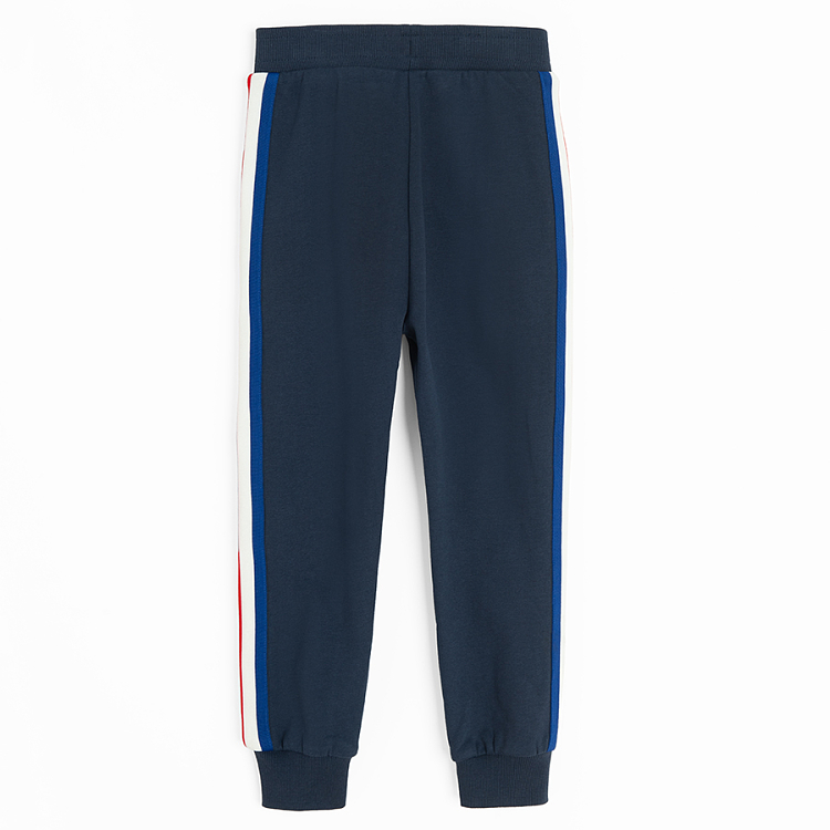 Blue jogging pants with white and red stripes on the side