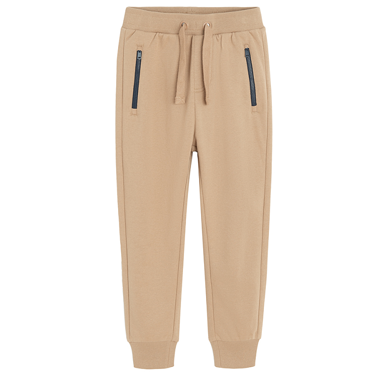 Brown jogging pants with corded waist and elastic around the ankles