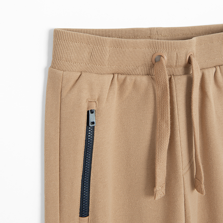 Brown jogging pants with corded waist and elastic around the ankles