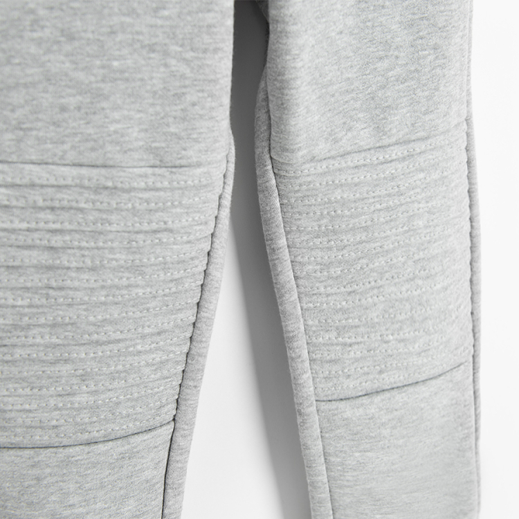 Grey jogging pants with design on the knees