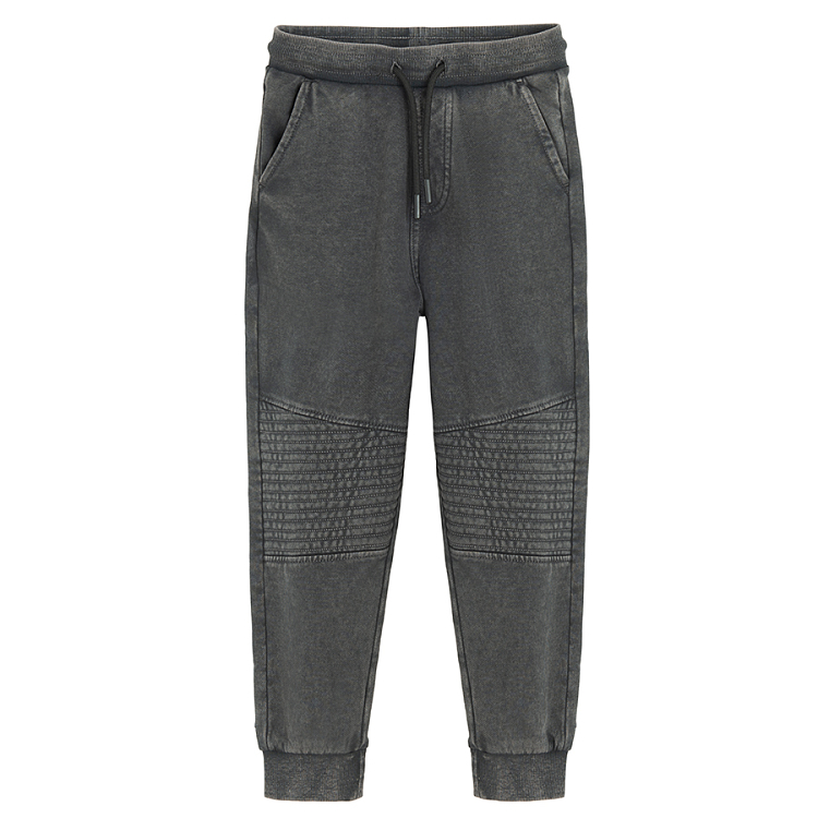 Grey jogging pants with corded waist and elastic around the ankles