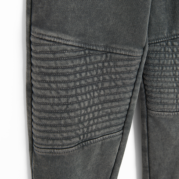 Grey jogging pants with corded waist and elastic around the ankles