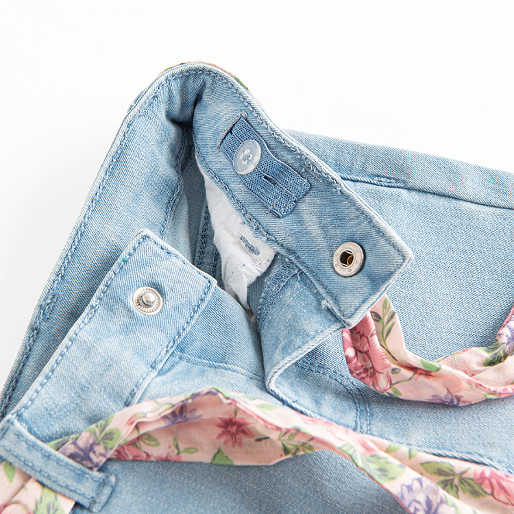 Light blue denim trousers with floral belt