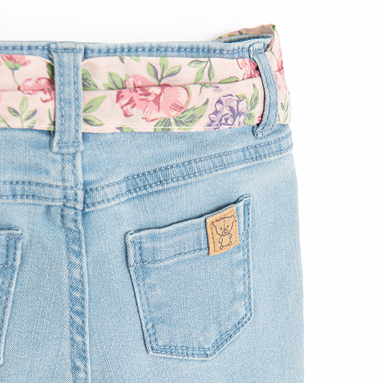 Light blue denim trousers with floral belt