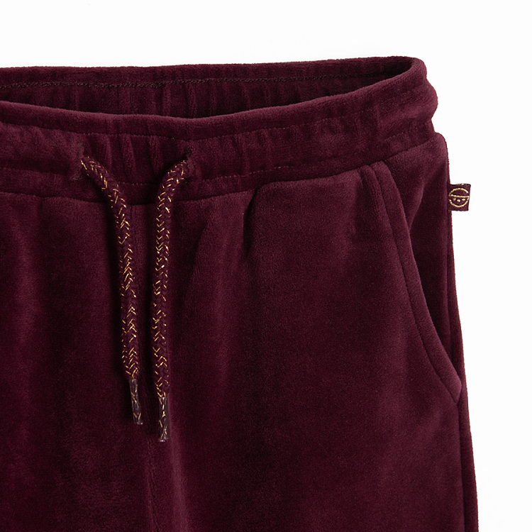 Burgundy jogging pants with kitten on knees