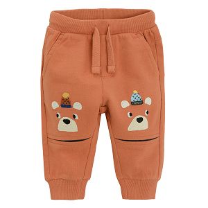 Brown jogging pants with bears print with pom pom caps on the knees