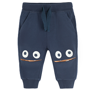 Dark blue jogging pants with monster face on the knees print