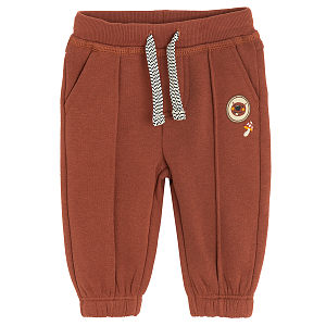 Brown jogging pants with bear print