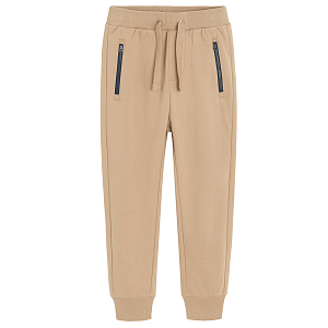 Brown jogging pants with corded waist and elastic around the ankles