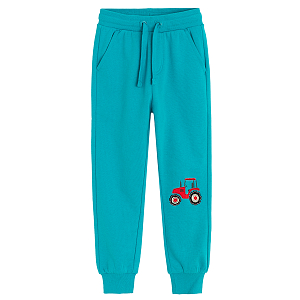 Light blue jogging pants with tractor print