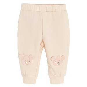 Ecru jogging pants with bear print