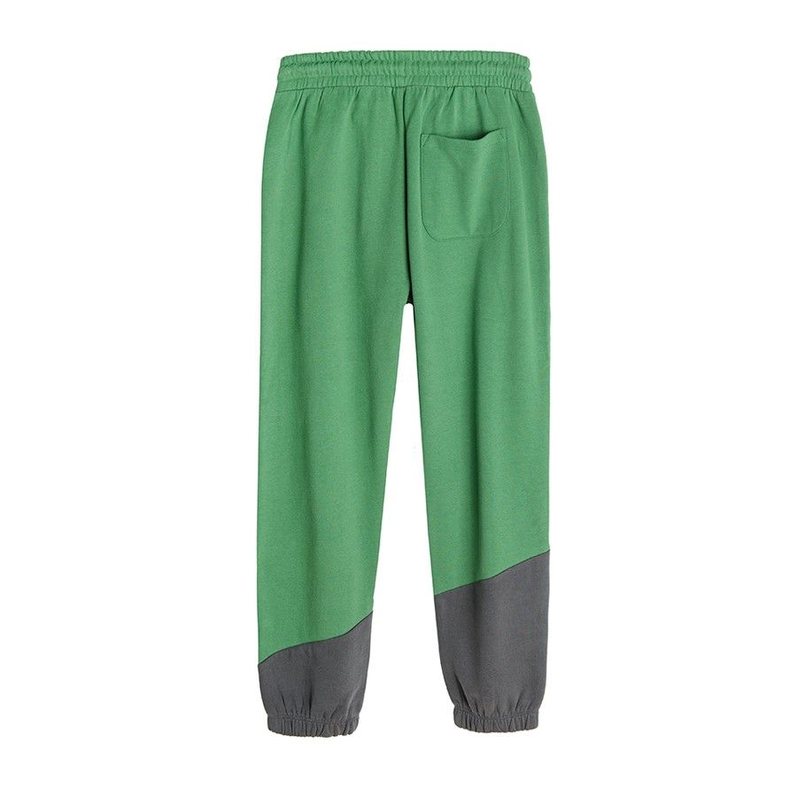 Green jogging pants with cord on the waist and elastic ankle