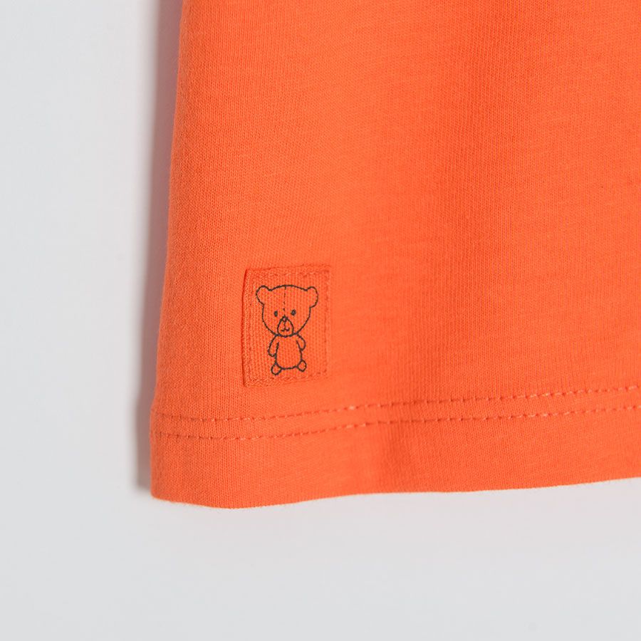 Orange short sleeve T-shirt with dinosaurs print