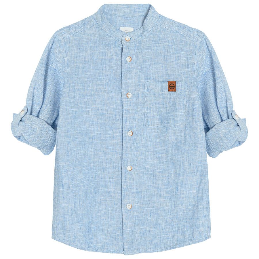 Light blue denim long sleeve button down shirt that rolls up to a button