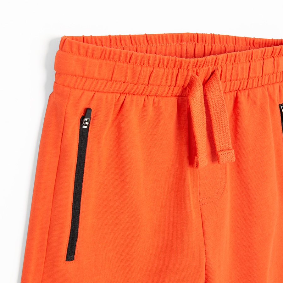 Orange bermuda shorts with cord on the waist