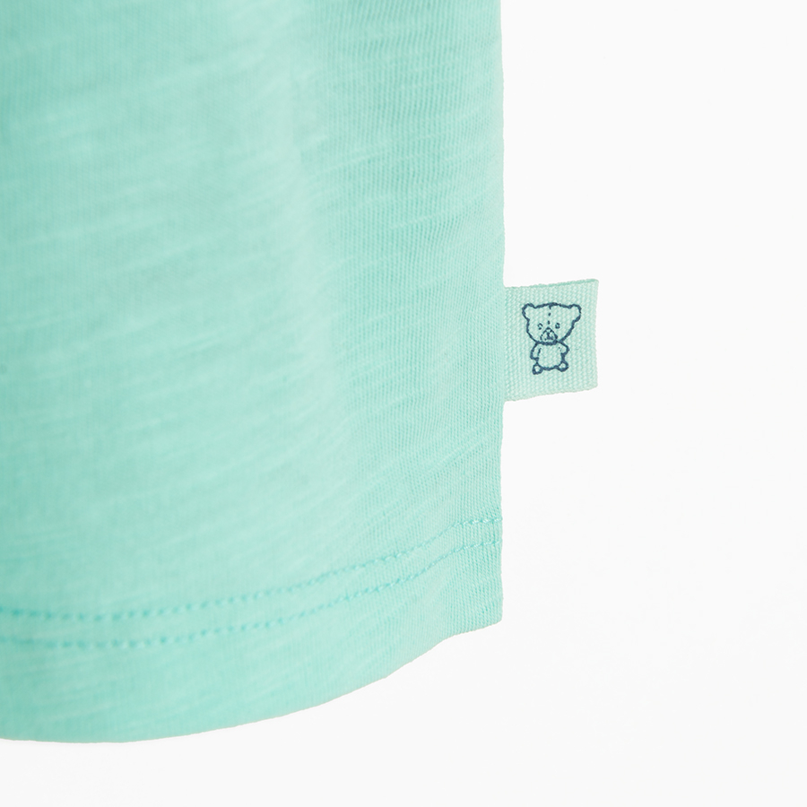 Turquoise polo T-shirt with Born to Surf print on the back