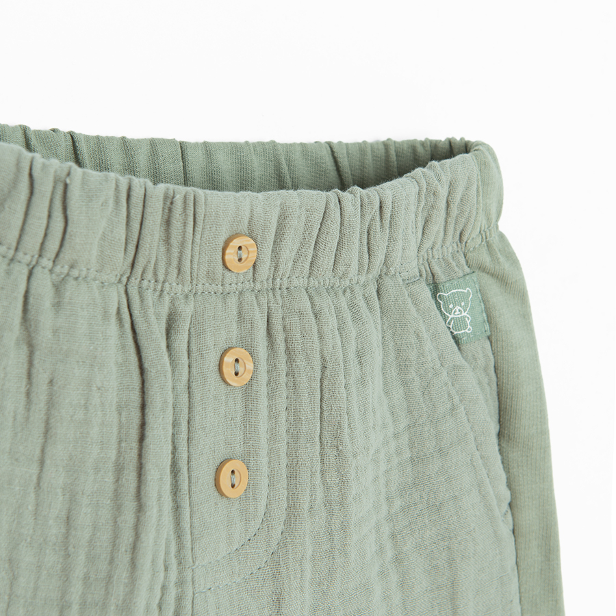 Khaki shorts with buttons in the middle