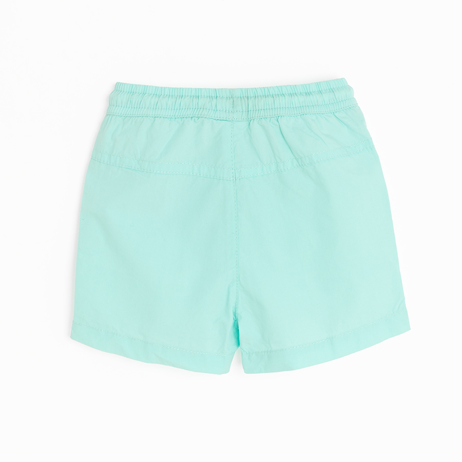 Light turquoise shorts with cord on the waist