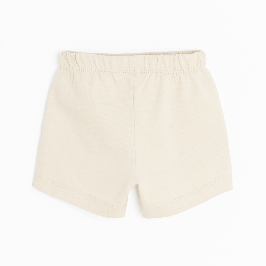 Beige shorts with buttons in the middle