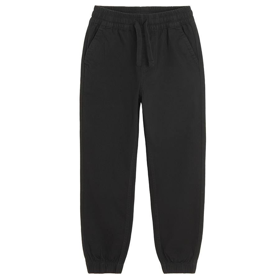 Black trousers with corded waist and elastic around the ankles