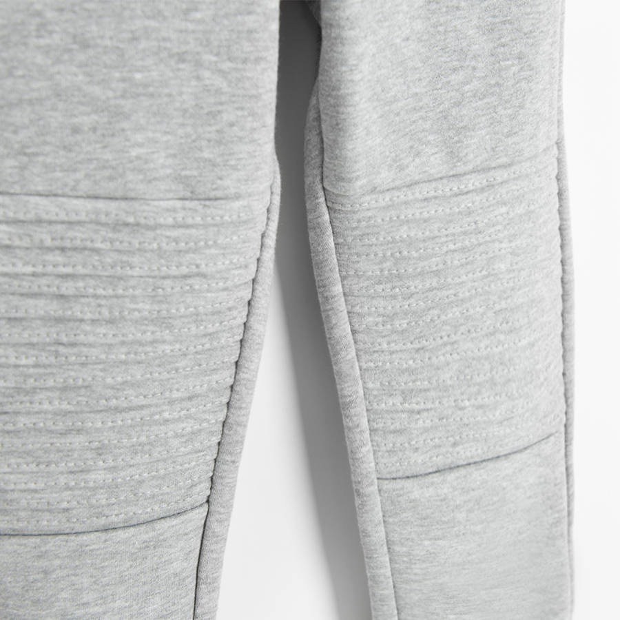 Grey jogging pants with design on the knees