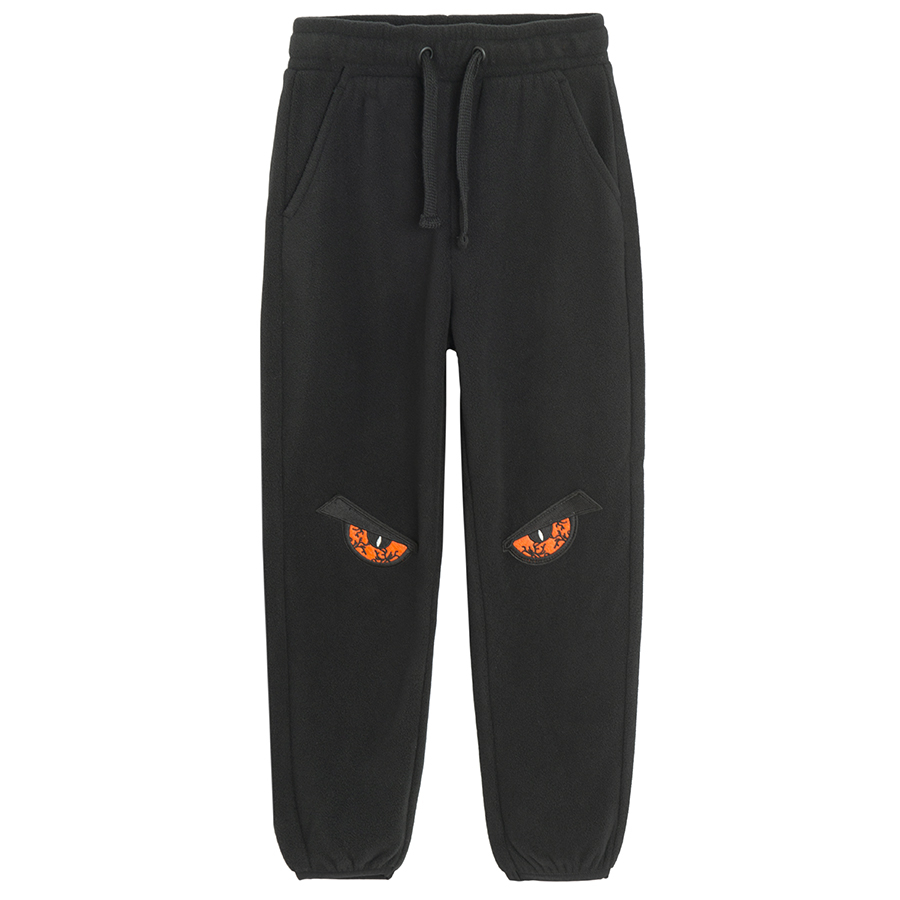 Dark grey jogging pants with angry eyes print