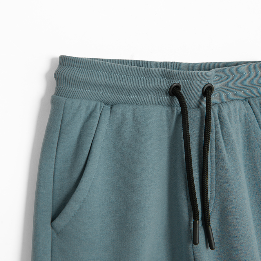 Black and blue jogging pants with external side pockets