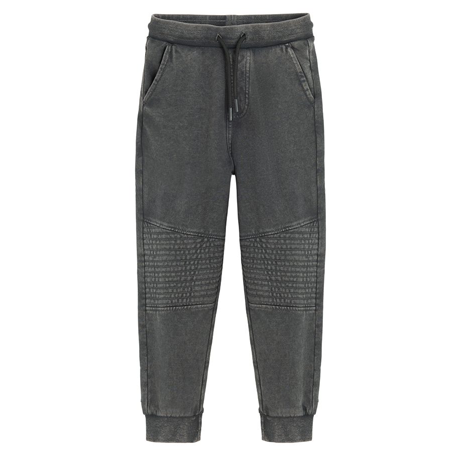 Grey jogging pants with corded waist and elastic around the ankles