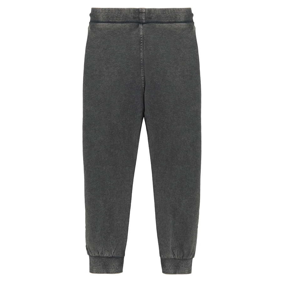 Grey jogging pants with corded waist and elastic around the ankles