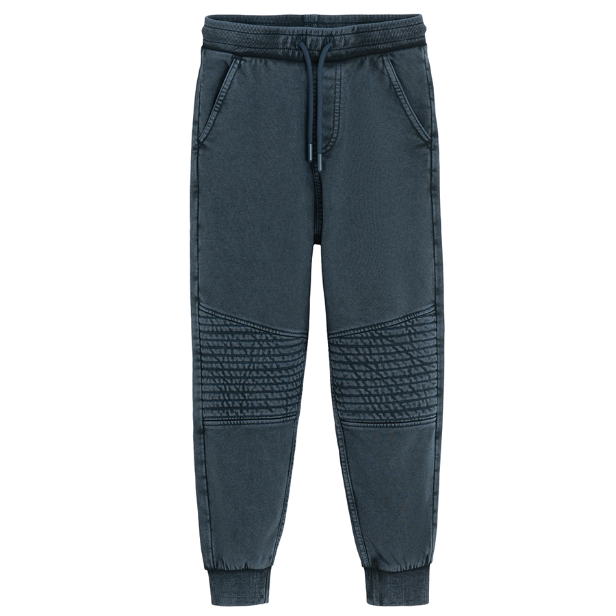 Blue jogging pants with corded waist and elastic around the ankles