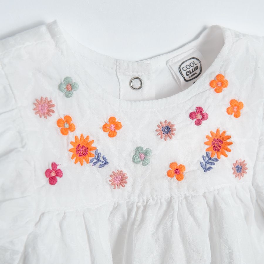 Cream short sleeve blouse with embroidery on the top and ruffle on shoulders