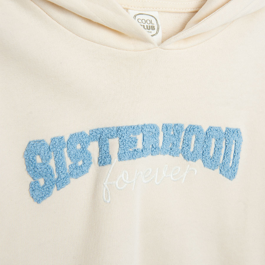 White hooded sweatshirt with 'SISTERHOOD' print