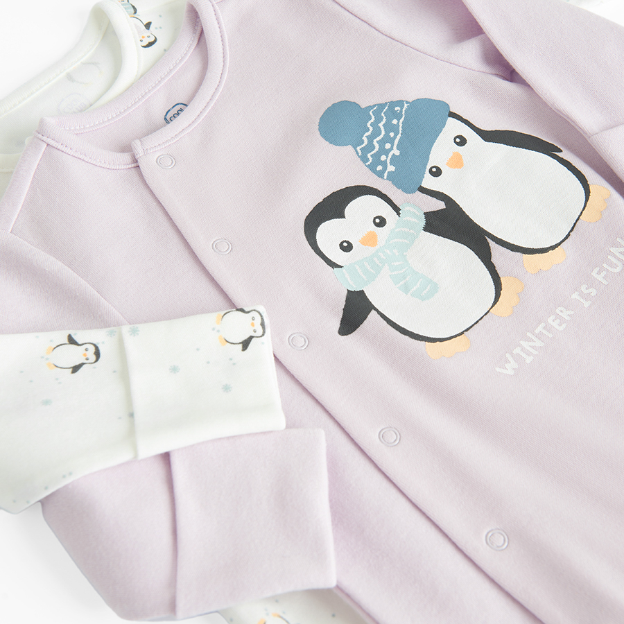 White and purple footed overalls with penguin print and side buttons