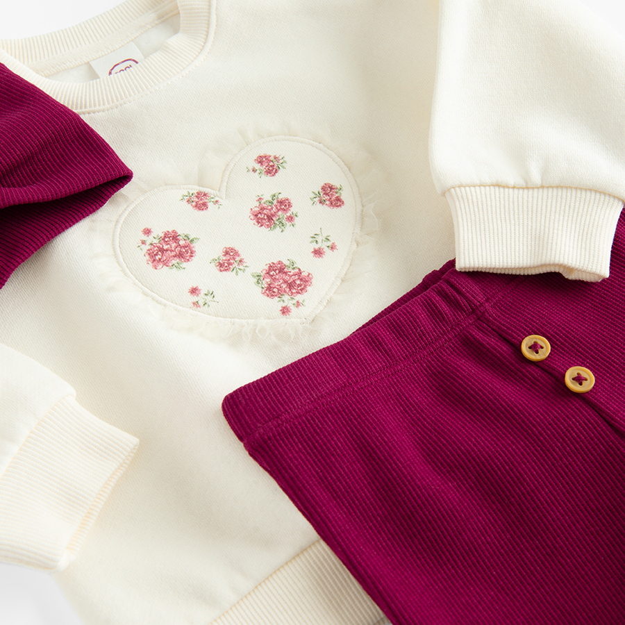 White sweatshirt with a heart print and burgundy leggings and headband