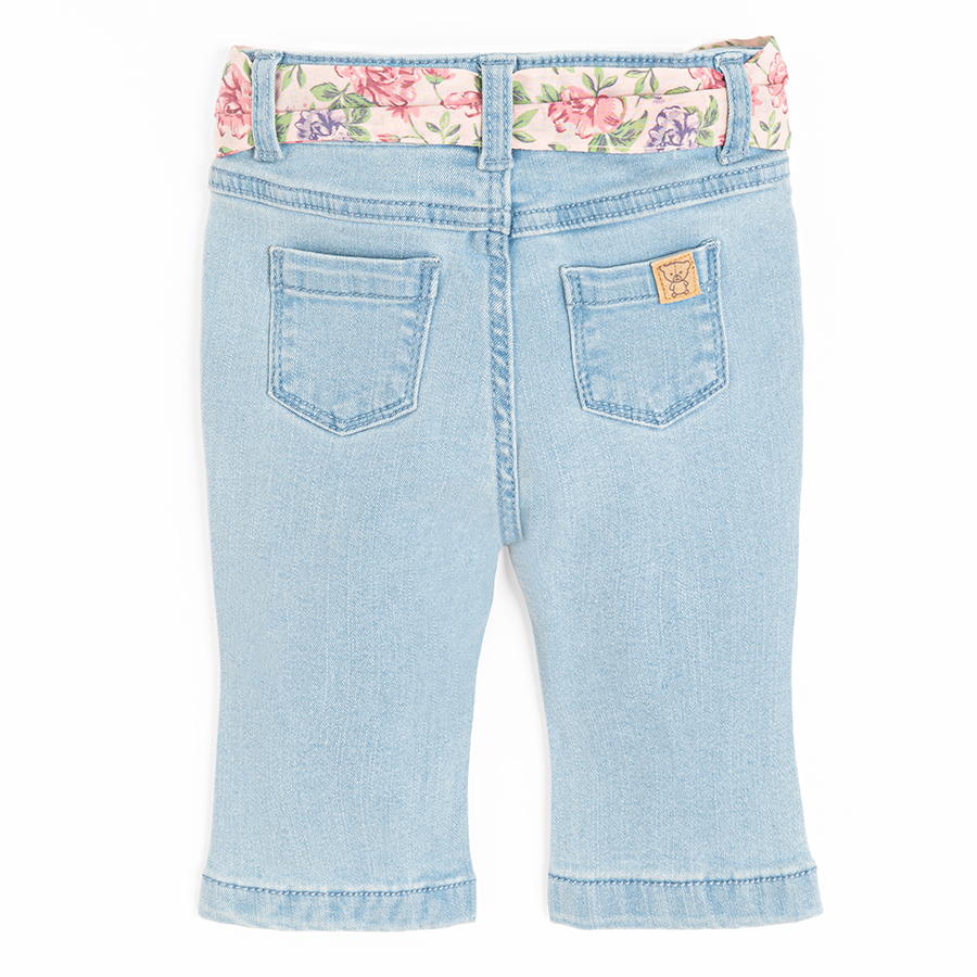 Light blue denim trousers with floral belt