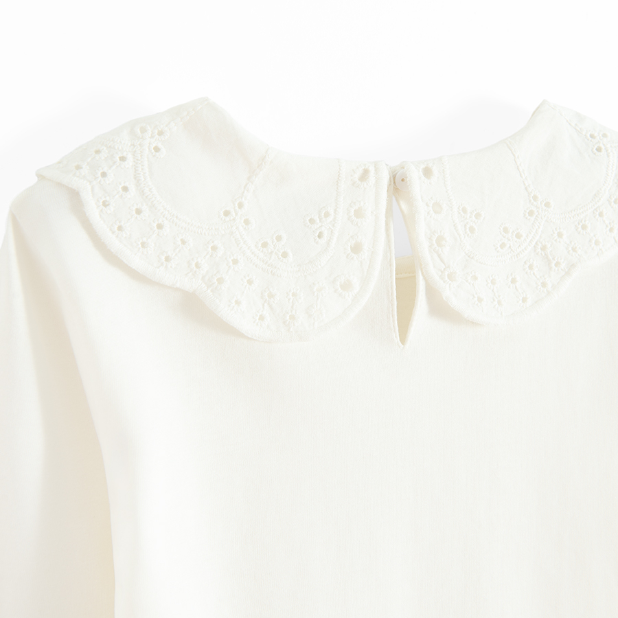 White long sleeve blouse with ruffle on the neckline