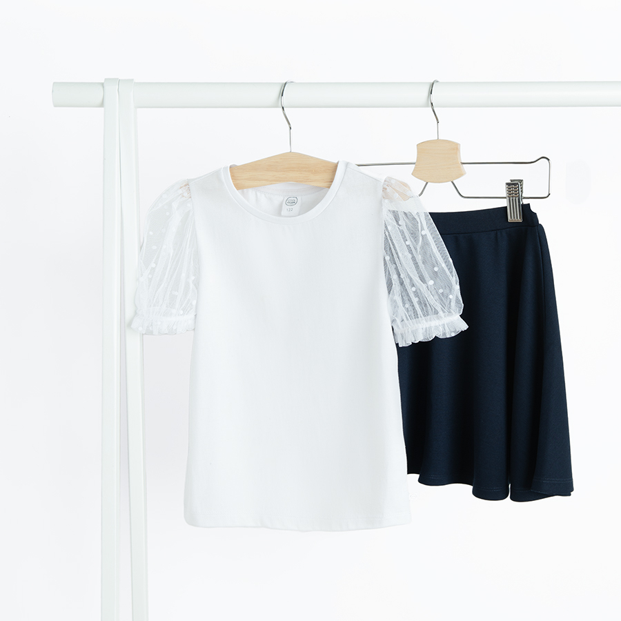 White short sleeve blouse with puffy sleeves and blue skirt