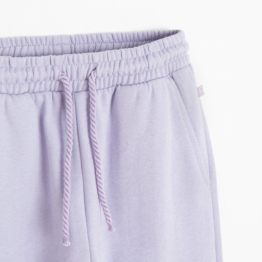 Purple jogging pants with unicorn print on the knees