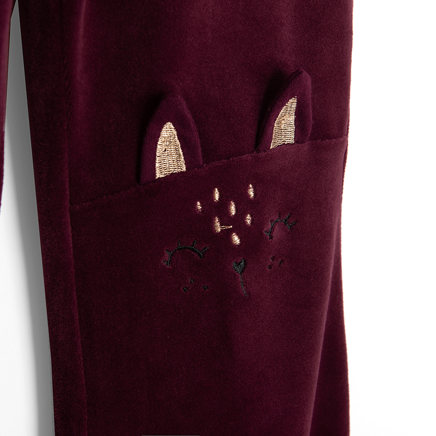 Burgundy jogging pants with kitten on knees